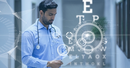 Digital composite of Doctor looking at his tablet surounded with futuristic interface