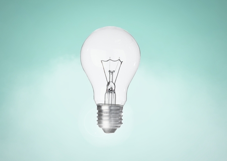 Digital composite of Light bulb against turqouise backgroundの写真素材