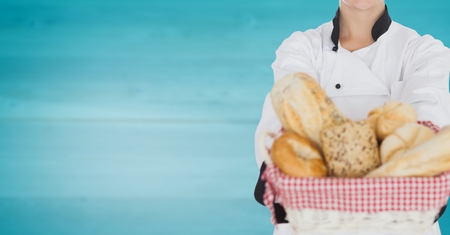 Digital composite of Chef with bread against blurry blue wood panelの写真素材