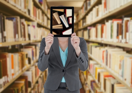 Digital composite of Business woman with tablet showing standing books against blurry bookshelves...