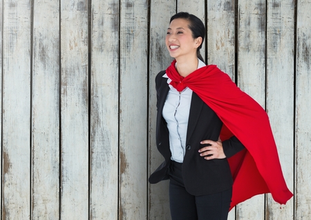 Digital composite of Business Superhero against woodの写真素材