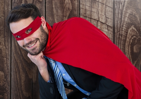 Digital composite of Business Superhero against woodの写真素材