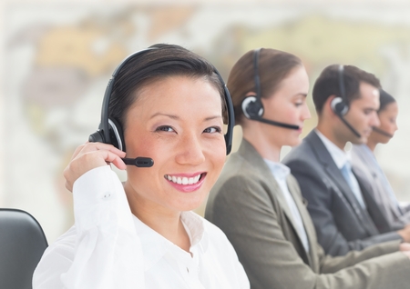 Digital composite of Travel agents with headsets against blurry mapの写真素材