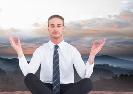 Digital composite of Man Meditating peacefully in mountainsの写真素材