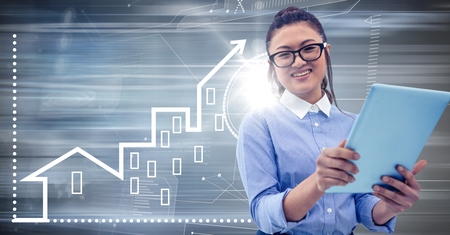 Digital composite of Woman with tablet against motion blur with white house graphicの写真素材