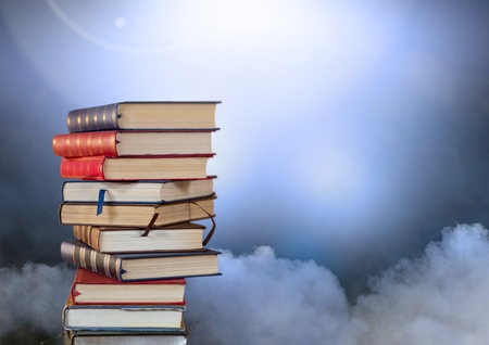 Digital composite of Books stacked by atmospheric cloudsの写真素材