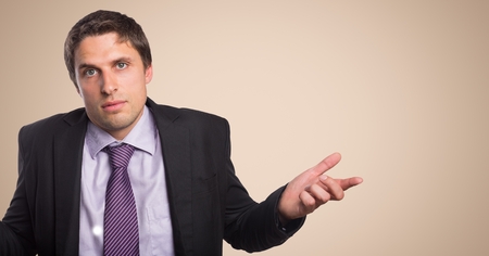 Digital composite of Business man shrugging against cream backgroundの写真素材