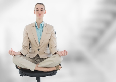 Digital composite of Businesswoman Meditating with bright backgroundの写真素材