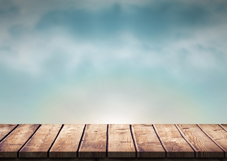 Digital composite of Wood table against blue evening skyの写真素材