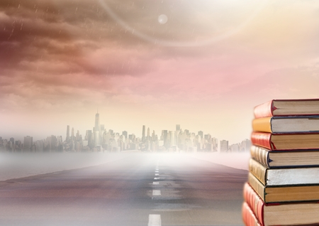 Digital composite of Books stacked by road to cityの写真素材
