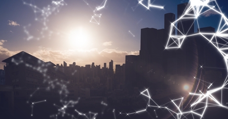 Digital composite of White network against dark skylineの写真素材