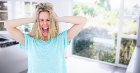 Digital composite of Stressed woman by glass doors at home