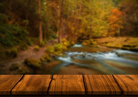 Digital composite of Wood table against blurry riverの写真素材