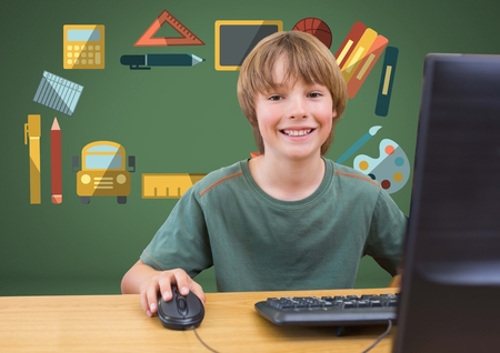 Digital composite of Young boy on computer with education graphic drawings