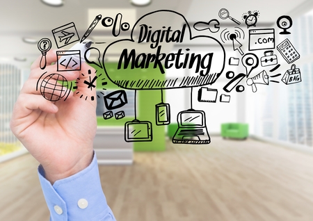 Digital composite of Hand with pen and black digital marketing doodles against blurry officeの写真素材