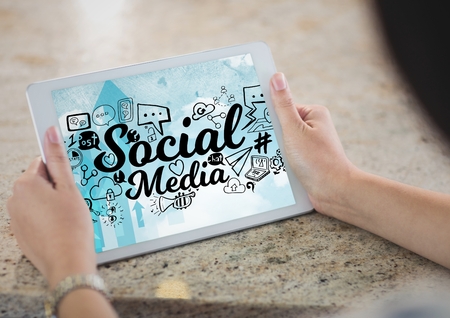 Digital composite of Hands holding tablet showing black social media doodles against skyの写真素材