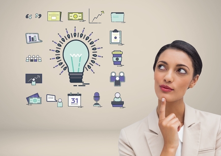 Digital composite of Businesswoman with idea with bulb and business graphic drawingsの写真素材