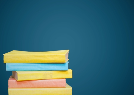 Digital composite of Pile of books against blue background