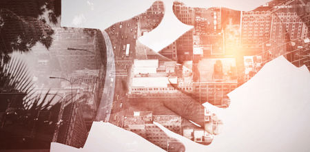 Front side of buildings against composite image of two people going to shake their handsの写真素材