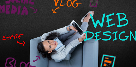 Woman on her tablet looking up against white background with vignetteの写真素材