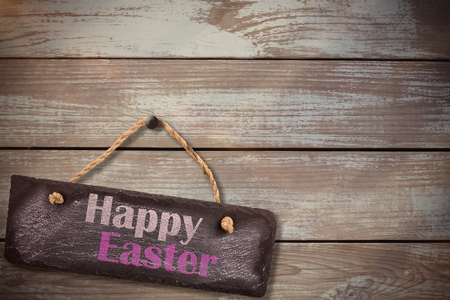 Easter greeting against woodの写真素材
