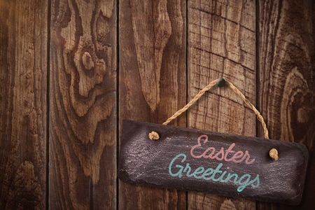 Easter greeting against wood panellingの写真素材