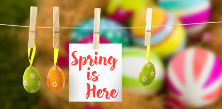 Easter greeting against painted easter eggs with flowers