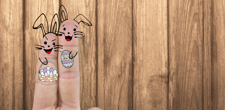 Illustration of fingers representing Easter bunny  against woodの写真素材