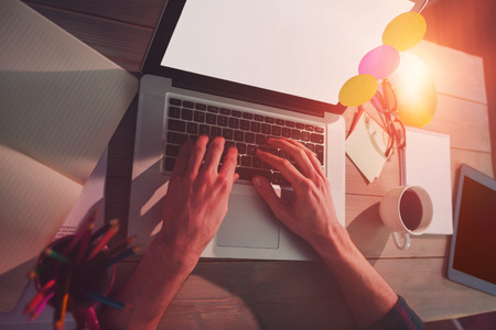 Cropped image of creative graphic designer using laptop in office
