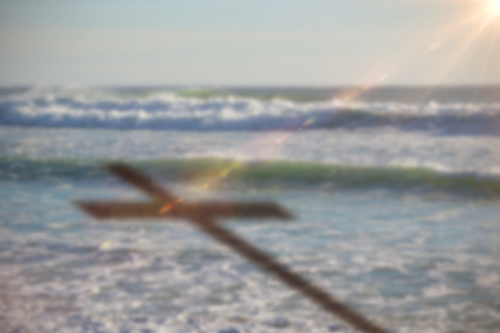 Close up of 3d wooden cross against water wavesの写真素材