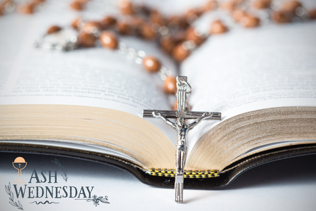 Easter message against cross of rosary beads resting against bibleの写真素材