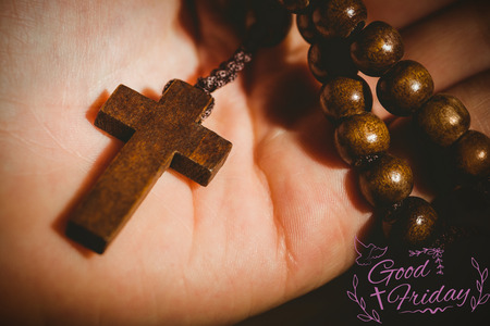 Easter message against hand holding rosary beadsの写真素材