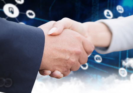 Composite image of business people doing handshakeの写真素材