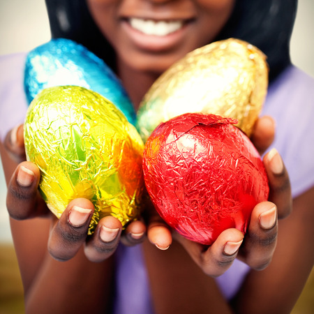 Harvester machine working on field against close up of a woman showing colorful easter eggsの写真素材