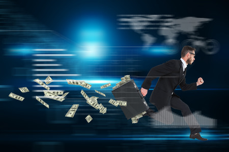 Running businessman against floating numbers on black backgroundの写真素材
