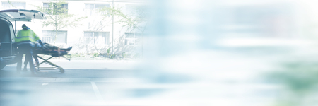 Blurry new york street against ambulancemen carrying injured man on stretcherの写真素材