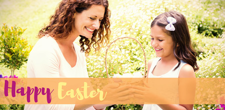 Happy mother and daughter collecting easter eggs against easter greeting