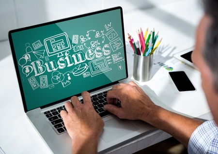 Digital composite of Man at laptop showing white business doodles against teal backgroundの写真素材
