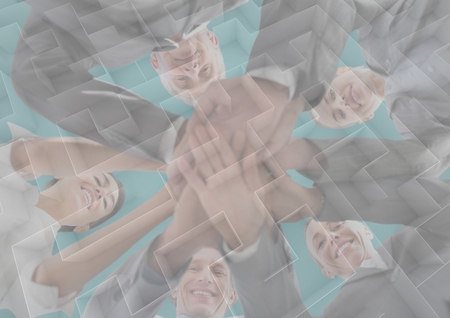 Digital composite of Business team putting hands together with maze graphic overlay and teal backgroundの写真素材