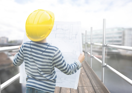 Digital composite of Boy looking blueprint in 3D scaffolding