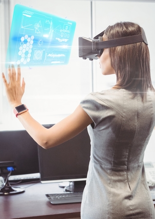 Digital composite of Woman in office wearing VR Virtual Reality Headset with Interface
