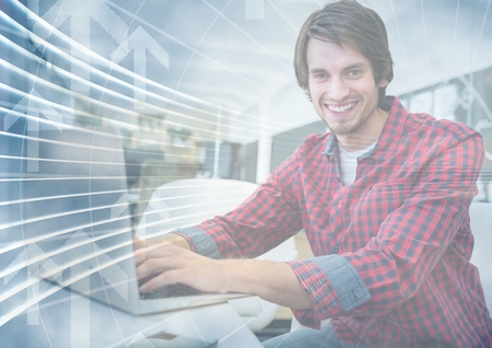 Digital composite of Man with laptop behind arrow graphic overlayの写真素材