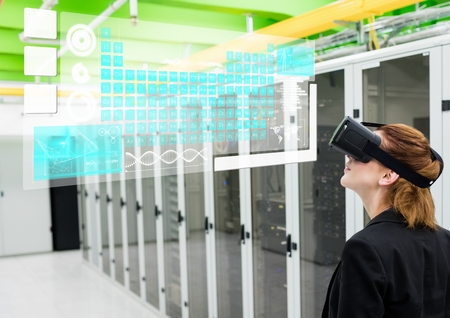 Digital composite of Woman near servers wearing VR Virtual Reality Headset with Interface