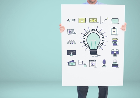 Digital composite of Man holding card with idea with bulb and business graphic drawingsの写真素材