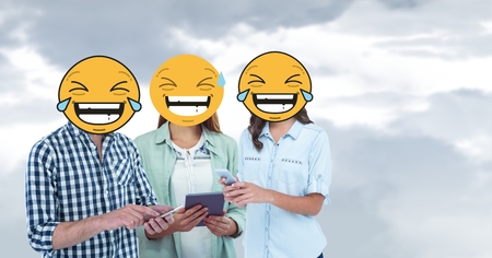 Digital composite of Digital composite of friends with laughing emojis using smart phones and digital tabletの写真素材