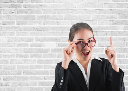 Digital composite of Businesswoman pointing upの写真素材