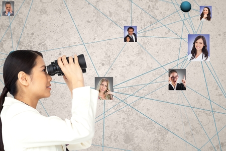 Digital composite of Businesswoman looking at candidates through binocularsの写真素材
