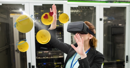 Digital composite of Businesswoman touching various emojis seen through VR glasses in office