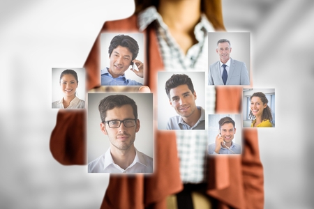 Digital composite of Midsection of businesswoman selecting candidatesの写真素材