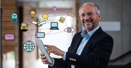 Digital composite of Digitally generated image of various icons with businessman using digital tablet in officeの写真素材